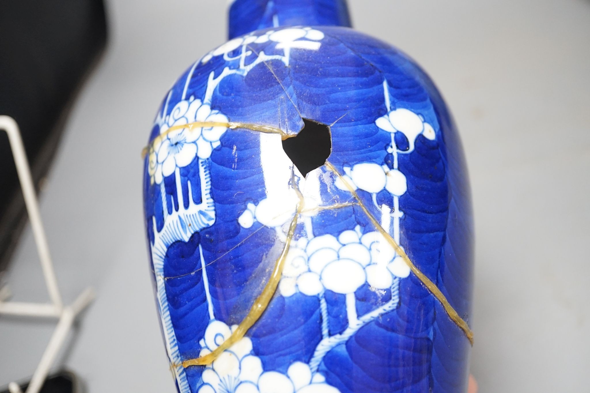 A Chinese blue and white Prunus vase, a Chinese enamelled porcelain bowl and a pale blue crackle glaze vase, tallest 32 cm